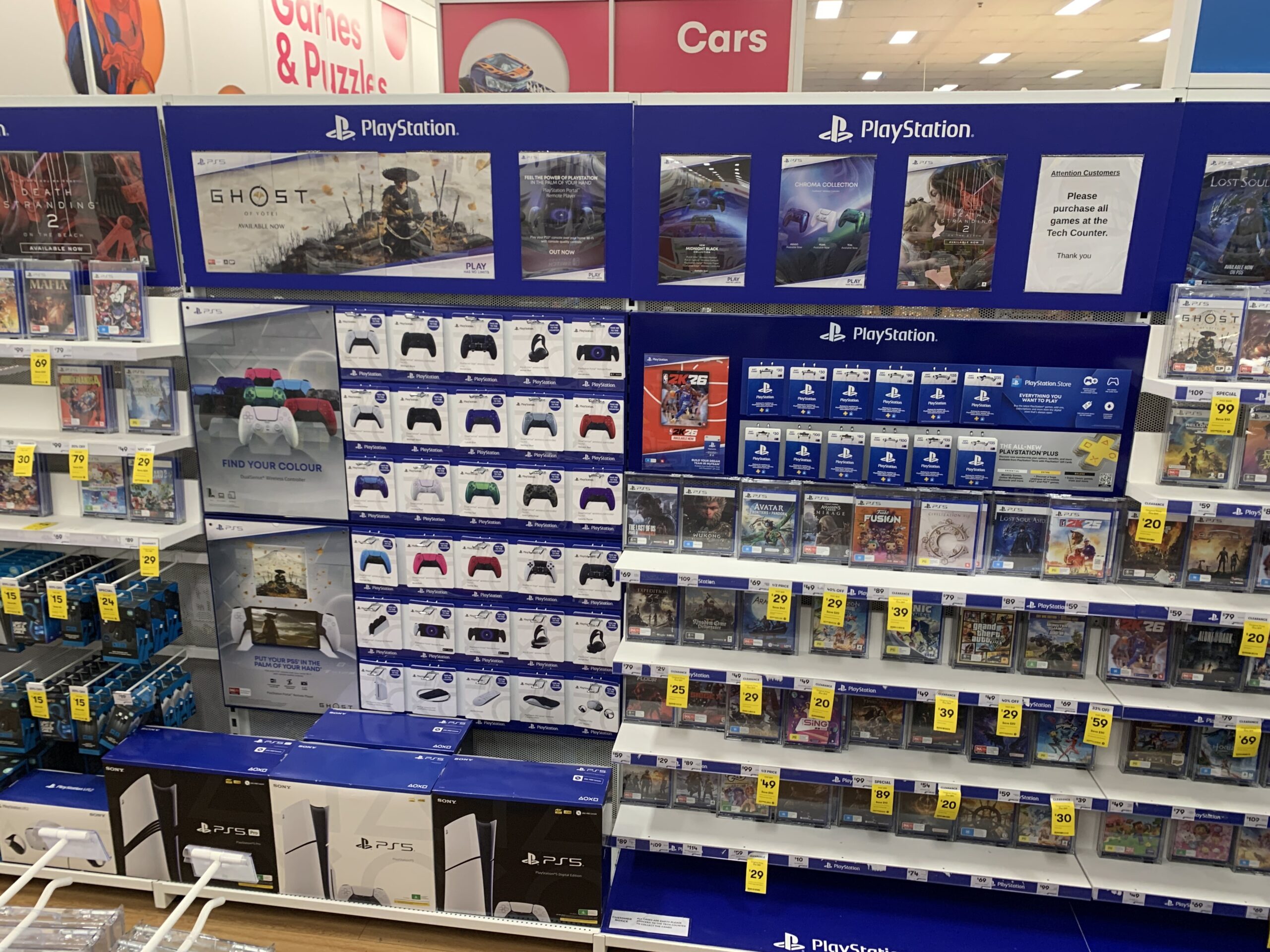 Sony Playstation wall bay point of sale display in Big W retail shop with stock on the shelves